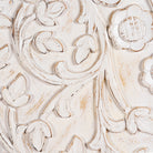 Close up image of an arched wooden wardrobe made of mango wood with hand-carved floral details; hand carved wooden furniture in Ibiza style, 190 × 100 × 40 cm.
