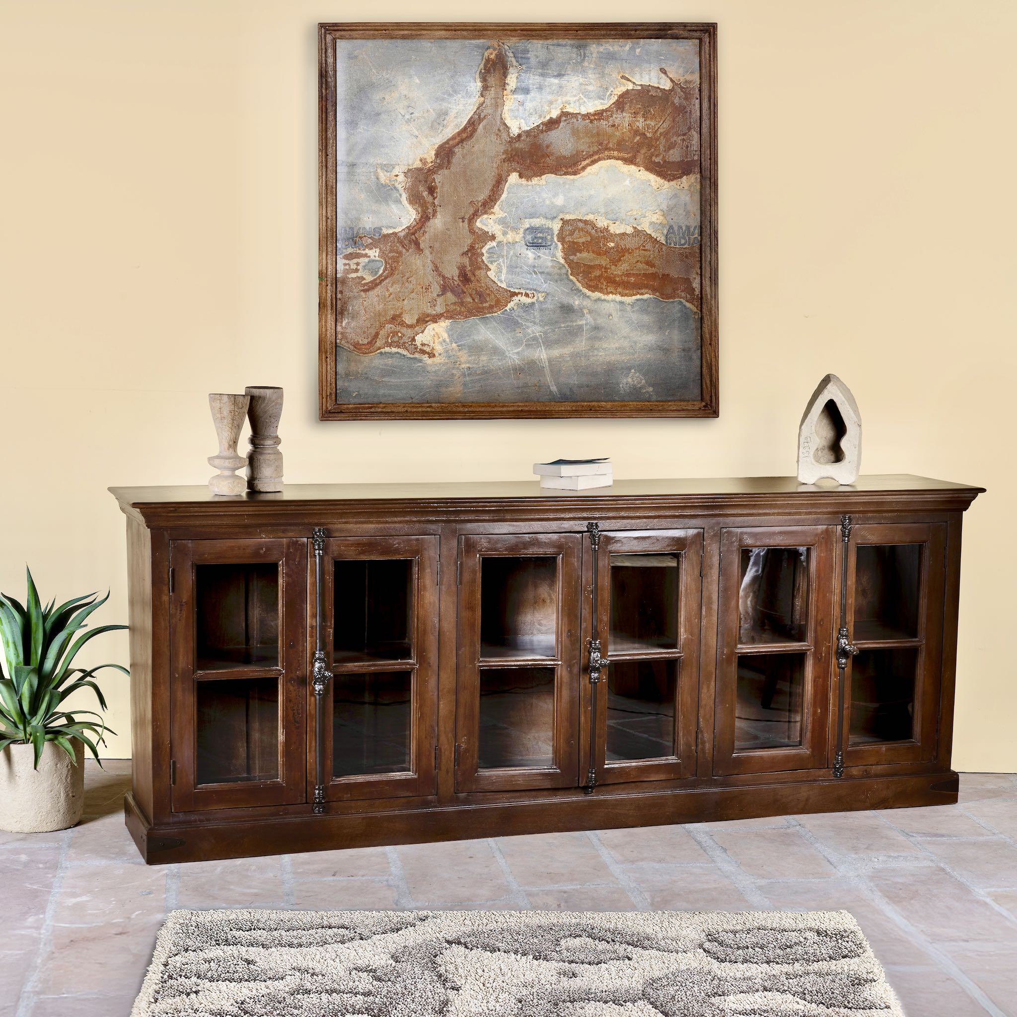 Side angle image of a reclaimed teak furniture sideboard with glass doors, rustic living room furniture with boho style, 257 × 46 × 100 cm.