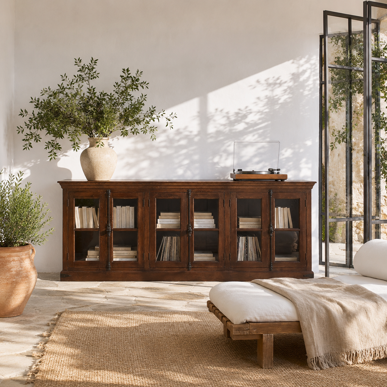 Lifestyle image of a reclaimed teak furniture sideboard with glass doors, rustic living room furniture with boho style, 257 × 46 × 100 cm.