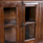 Close up image of a reclaimed teak furniture sideboard with glass doors, rustic living room furniture with boho style, 257 × 46 × 100 cm.