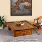 Side angle image of a rustic square mango wood coffee table with raised edge, vintage-style entryway or living room furniture, 120×120×40 cm.