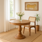 Lifestyle imagination of a round solid wood dining table made from reclaimed teak with carved pedestal base; rustic reclaimed teak wood dining table, 100 cm diameter × 78 cm height.