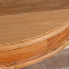 Close up image of a round solid wood dining table made from reclaimed teak with carved pedestal base; rustic reclaimed teak wood dining table, 100 cm diameter × 78 cm height.