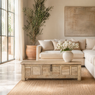 Lifestyle image of a Ibiza style carved mango wood chest with sandblasted finish and iron lock; 150 × 40 × 45 cm.