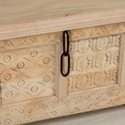 Close up image of a Ibiza style carved mango wood chest with sandblasted finish and iron lock; 150 × 40 × 45 cm.