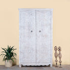 Image of a hand carved white washed mango wood wardrobe in vintage design.