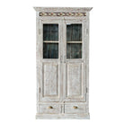White background image of a reclaimed teak wood cabinet in shabby chic white with glass doors and ceramic inlays – dining room furniture with vintage elegance.