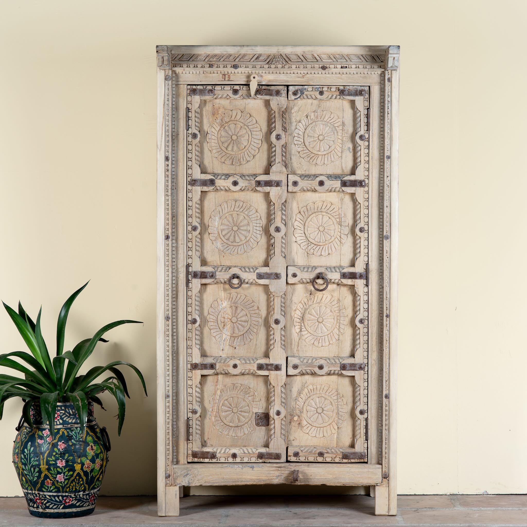 Reclaimed teak wood cabinet Ahara with Mediterranean design, featuring hand-carved antique Indian doors and metal accents. A unique piece of old door furniture ideal for stylish, character-rich living room storage.