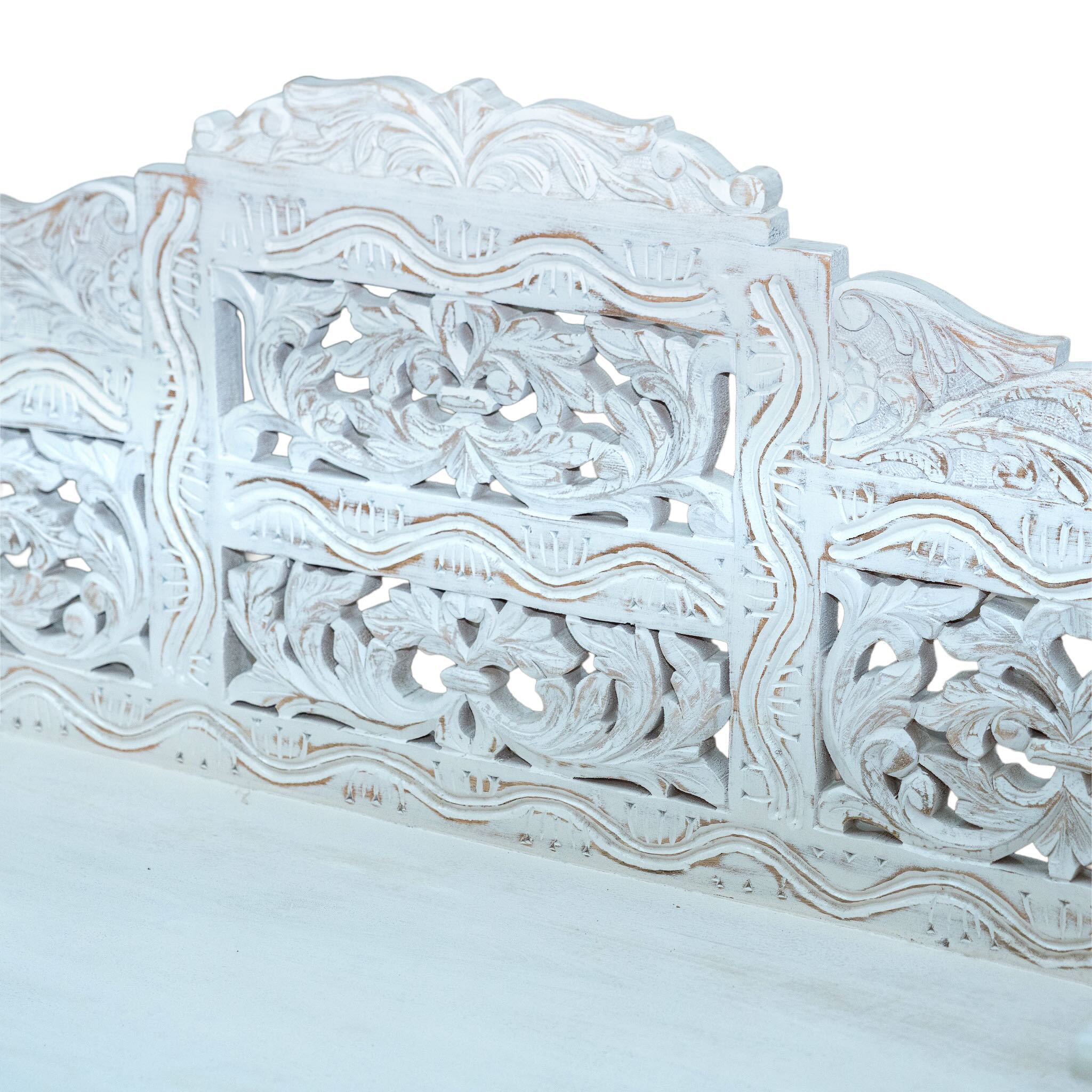 Close up image of a hand carved mango wood bench, featuring intricate floral detailing and turned legs, representing traditional Indian craftsmanship and authentic hand carved wooden furniture design.