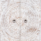 Close up image of an Aila handcrafted solid mango wood wardrobe with intricately hand-carved Indian doors, four spacious storage compartments, natural wood grain, and Mediterranean-inspired design, 180cm.