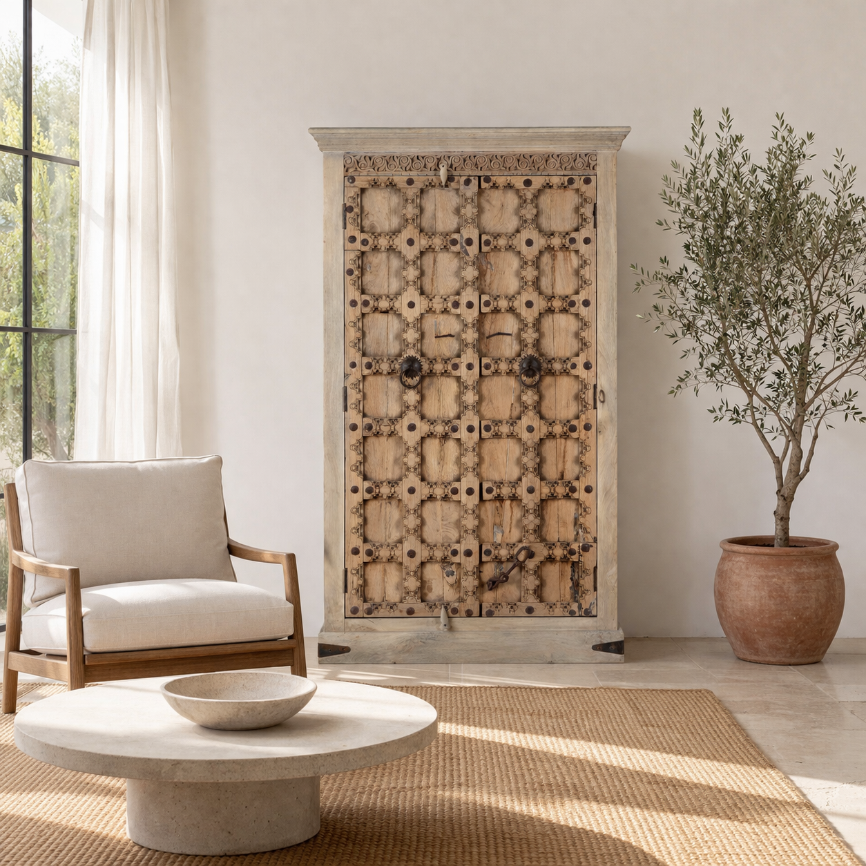 Lifestyle imagination of a reclaimed wood wardrobe Akhila featuring an old Indian door front with carved details and iron hardware. A sustainable furniture piece and unique old door cabinet for soulful, heritage-inspired interiors.