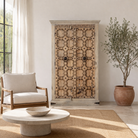 Lifestyle imagination of a reclaimed wood wardrobe Akhila featuring an old Indian door front with carved details and iron hardware. A sustainable furniture piece and unique old door cabinet for soulful, heritage-inspired interiors.