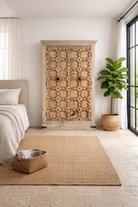 Lifestyle imagination of a reclaimed wood wardrobe Akhila featuring an old Indian door front with carved details and iron hardware. A sustainable furniture piece and unique old door cabinet for soulful, heritage-inspired interiors.