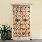Reclaimed wood wardrobe Akhila featuring an old Indian door front with carved details and iron hardware. A sustainable furniture piece and unique old door cabinet for soulful, heritage-inspired interiors.