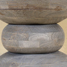 Close up image of a vintage style mango wood coffee table with rounded form and grey-washed finish; compact rustic accent table, 40 cm diameter, 46 cm height.