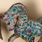 Close up image of a Aksham hand painted wooden horse sculpture on an iron stand with colourful floral and ornamental detailing, 40x15x30cm.