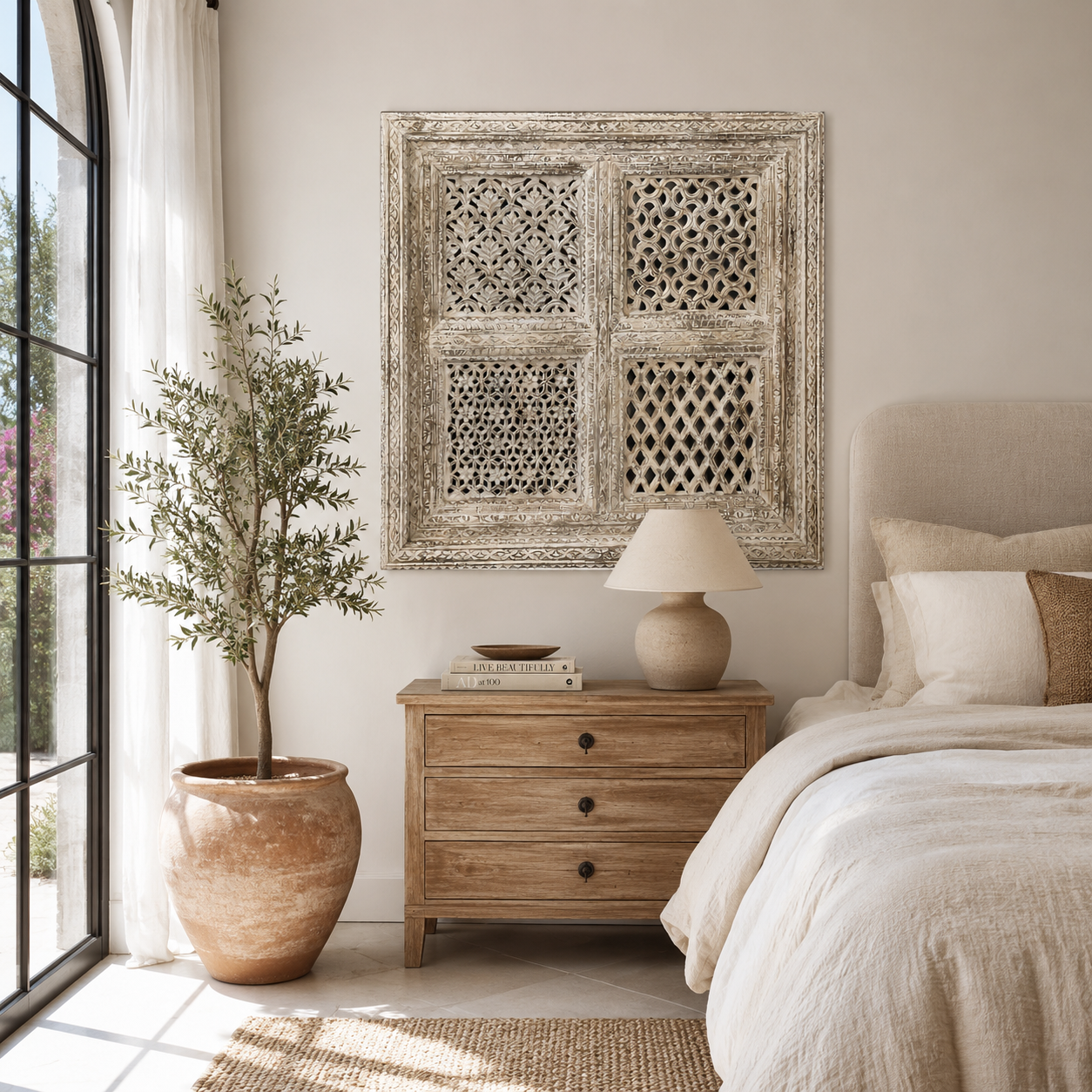 Lifestyle image of a square mango wood wall panel Akupara with intricate hand-carved detailing in soft, natural tones. A piece of unique wooden wall art perfect for wood wall decoration and carved wood furniture collections.
