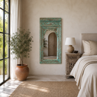 Lifestyle image of a hand carved wooden mirror made from antique Indian window frame, vintage green finish; 145 × 70 × 10 cm.