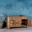 Open door image of a rustic design sideboard made from reclaimed wood with panelled doors, drawers, and iron accents; 150 × 40 × 90 cm.