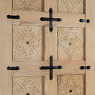 Wooden door with decorative patterns and metal hinges