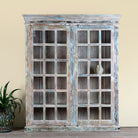 Reclaimed wood display cabinet Amara with distressed turquoise finish and glass-panelled doors. Sustainable living room furniture and vintage furniture piece with spacious shelving and authentic patina.