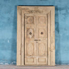Antique Indian door Amaya made of reclaimed teak with brass fittings, hand-carved details, extended frame, usable as entrance or vintage wall panels, 161 × 20 × 250 cm.