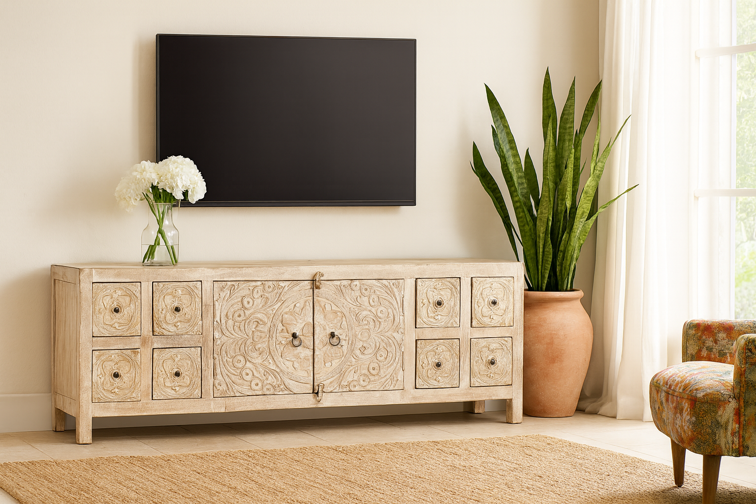 Lifestyle imagination of a whitewashed mango wood lowboard with hand-carved floral details, eight drawers and two compartments; ideal as a wooden lowboard or carved wood console table, 180 × 60 × 40 cm.