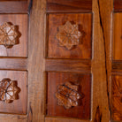 Close-up of a wooden panel with floral carvings