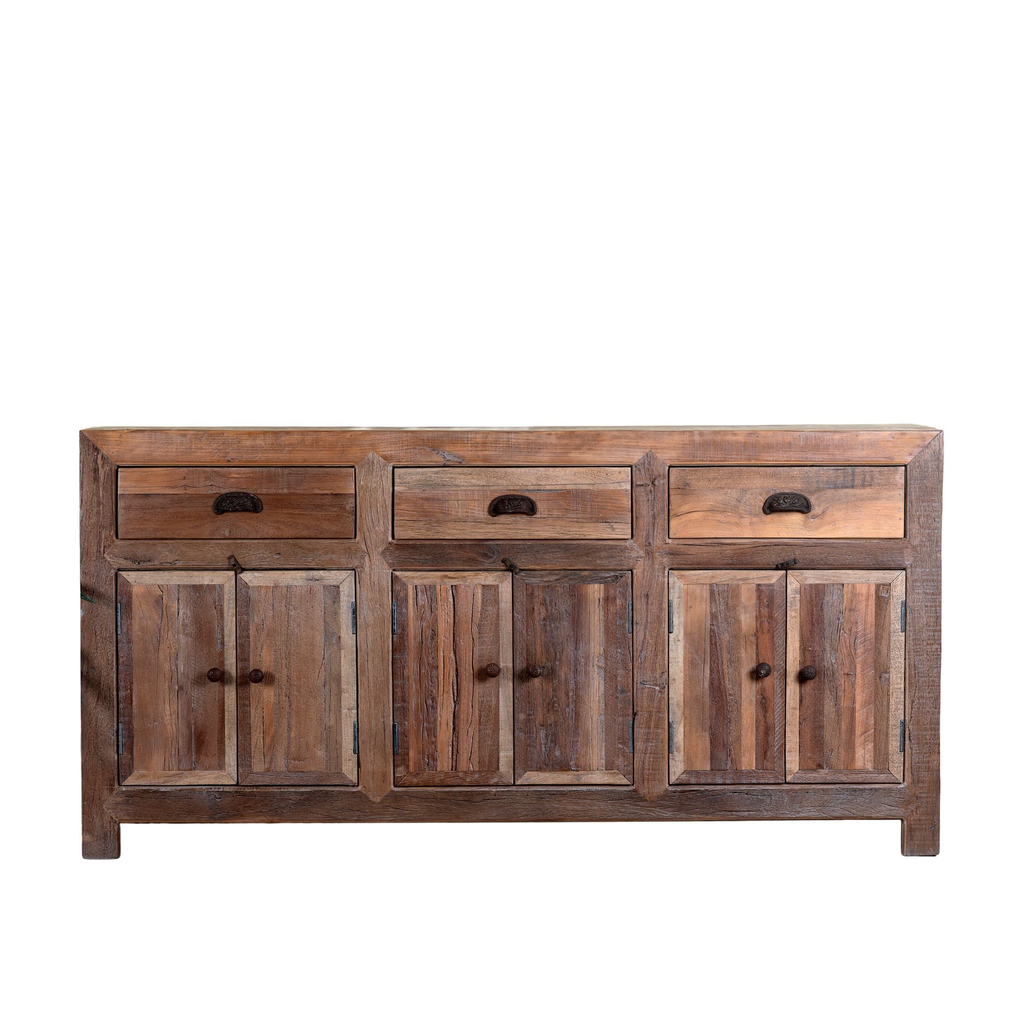 White background image of a reclaimed wood sideboard Amira in a rustic minimalist design, featuring three drawers and six doors with iron handles. A sustainable piece of living room furniture with natural textures and timeless appeal.