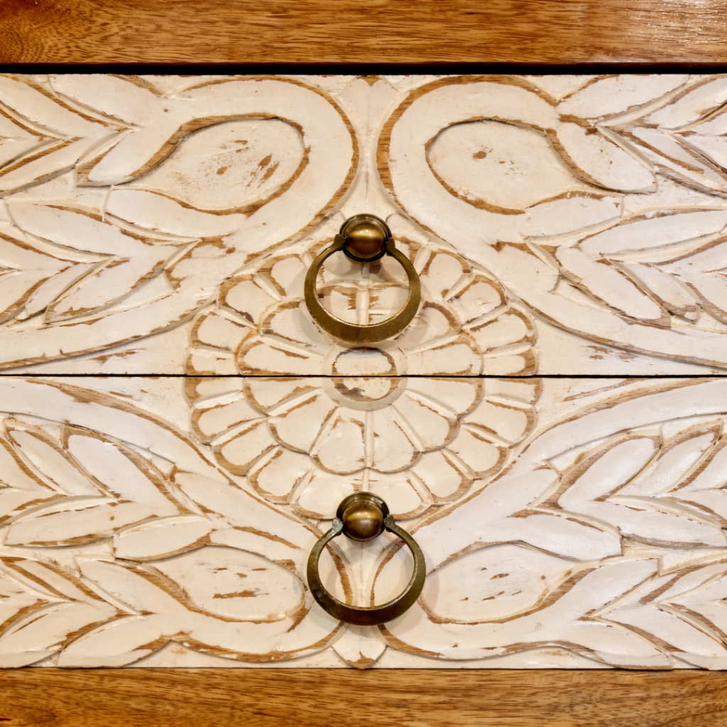 Close up image of a white washed mango wood console table with floral hand-carved drawers and lower shoe shelf; rustic mango wood furniture, 90 × 40 × 75 cm.