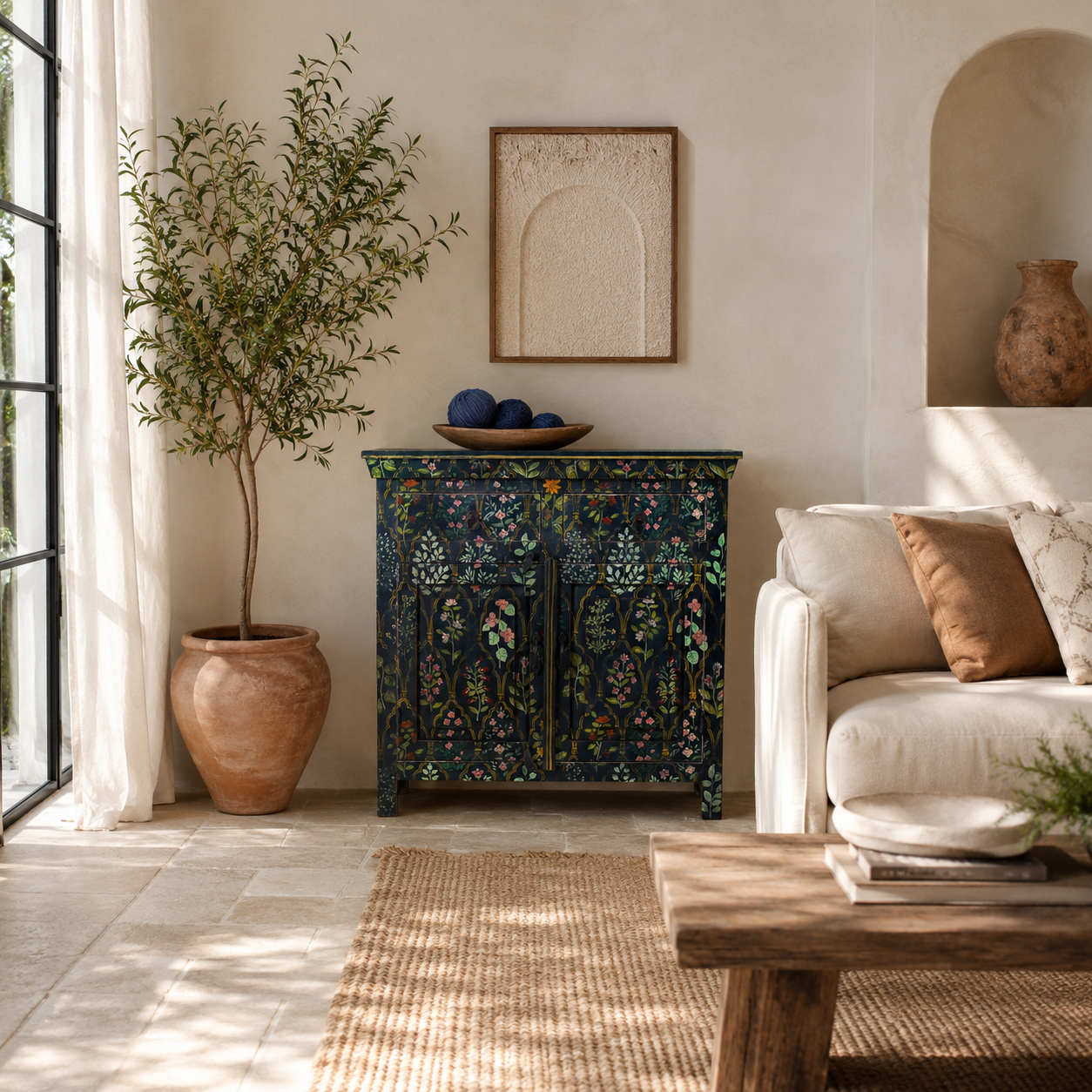 Lifestyle image of a hand painted cupboard made from recycled wood with floral motifs, two drawers and two doors, 90 × 90 × 40 cm.