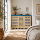 Lifestyle scene of a hand-painted reclaimed wood sideboard Amrit with floral motifs – a unique piece of sustainable furniture for vibrant Indian home decor.