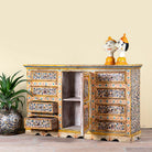 Side angle image showing open doors of a hand-painted reclaimed wood sideboard with floral motifs – a unique piece of sustainable furniture for vibrant Indian home decor.