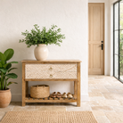 Lifestyle imagination of a white washed mango wood console table with floral hand-carved drawers and lower shoe shelf; rustic mango wood furniture, 90 × 40 × 75 cm.

