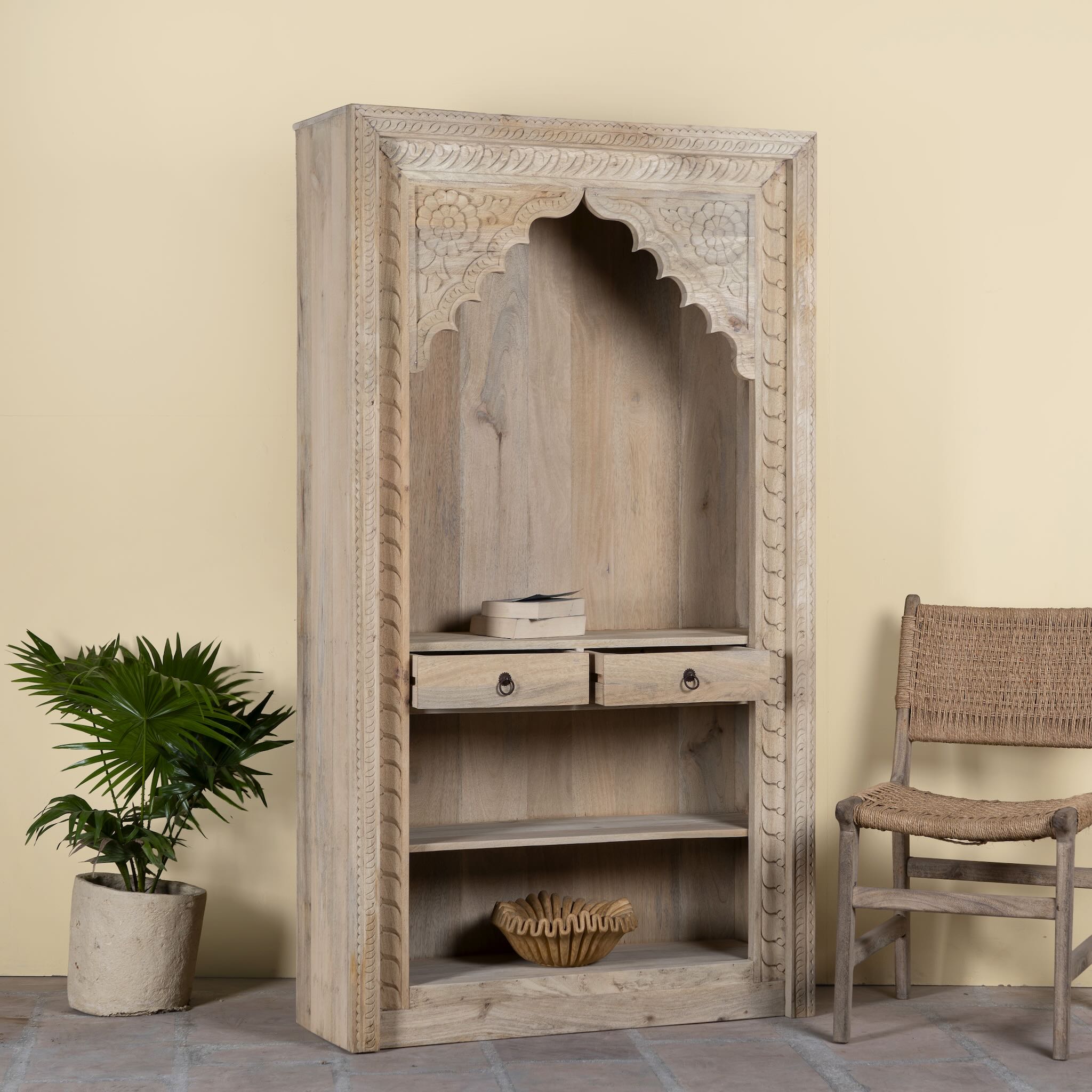 Side angle image with pen drawers of a hand carved entryway shelf with storage and two drawers made of mango wood, hand carved.