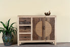 Reclaimed wood sideboard Amruta with three drawers and rattan-inlay cabinet doors in a circular design. A piece of sustainable furniture blending rustic wood textures and handcrafted detail.