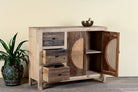 Side angle image with open doors of a reclaimed wood sideboard Amruta with three drawers and rattan-inlay cabinet doors in a circular design. A piece of sustainable furniture blending rustic wood textures and handcrafted detail.