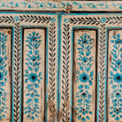 Close up image of a hand painted wooden furniture cabinet with floral motifs, reclaimed teak artisanal furniture in Mediterranean style, 95 × 40 × 152 cm.