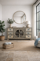 Lifestyle imagination of a hand-painted sideboard Anaya made from reclaimed wood with six drawers and two glass doors, featuring detailed animal and floral motifs. A sustainable piece of boho-style artisanal furniture with colourful heritage design.