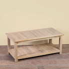 Side angle image of a Anil bleached reclaimed wood coffee table with rectangular top and full-width lower storage shelf, 120x60x50cm