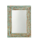 White background image of a carved mango wood mirror Animisha with turquoise finish and floral hand-carving. A statement piece for vintage home decor and Indian-inspired interiors.