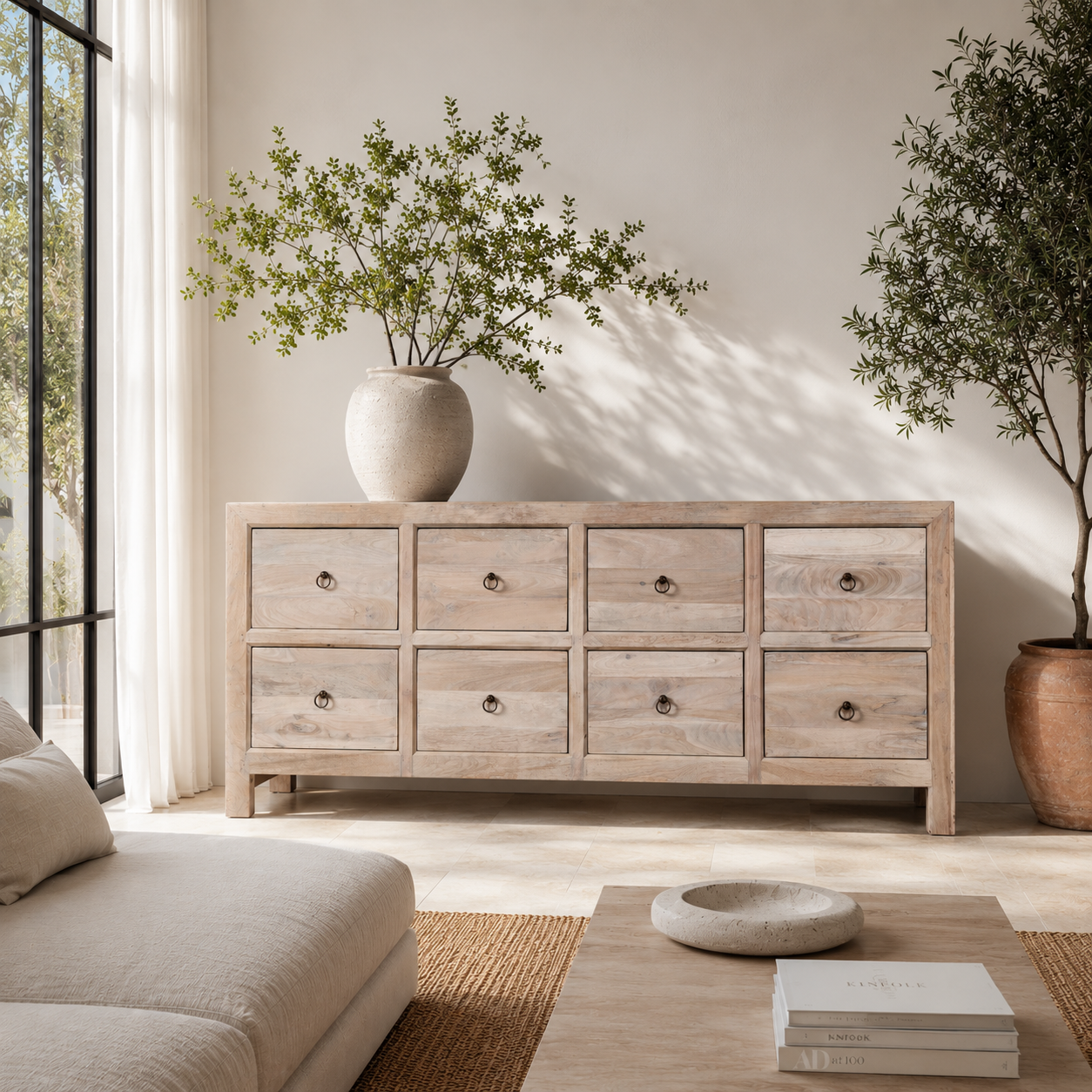 Lifestyle imagination of a Ibiza style chest of drawers made from sandblasted reclaimed wood, coastal furniture with 8 drawers and vintage metal pulls, 200 × 40 × 90 cm.
