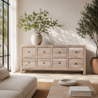 Lifestyle imagination of a Ibiza style chest of drawers made from sandblasted reclaimed wood, coastal furniture with 8 drawers and vintage metal pulls, 200 × 40 × 90 cm.