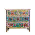 White background image of a hand-painted chest of drawers Anjana made from reclaimed wood, featuring four drawers with floral motifs in vibrant colours. A standout piece of sustainable furniture and painted wooden artistry.