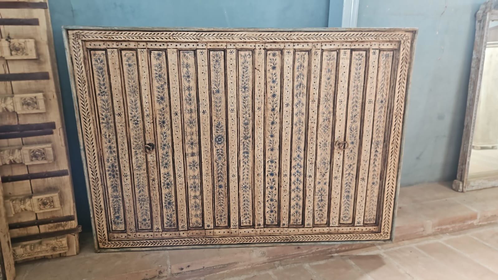 Anmol hand painted head board made from an antique Indian teak door, featuring traditional floral motifs in blue and cream and original iron hardware—an elegant example of hand painted head boards and authentic Indian headboards.