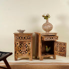 Open door picture of a pair of mango wood bedside tables with floral and geometric carvings; natural finish mango wood furniture ideal for bedroom furniture, 45 × 65 × 35 cm.