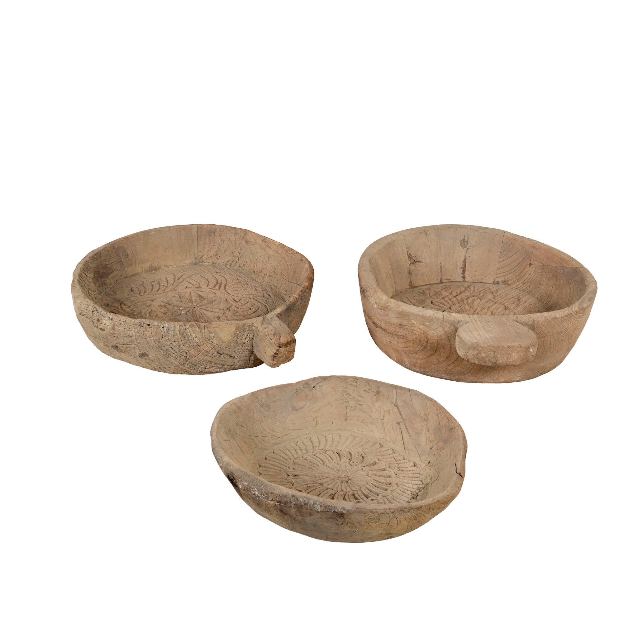 White background image of a hand-carved old teak wood plate with traditional Indian motifs and rustic finish, ideal for vintage home decoration and Indian home decor.