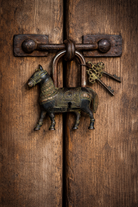 Handcrafted heart-shaped brass lock with engraved details and keys, a decorative brass accessory inspired by traditional Indian home accessories.