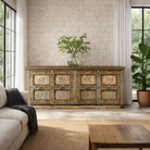 Lifestyle imagination of a unique sideboard made of recycled wood with hand painted Indian motifs in blue and gold; sustainable furniture for dining rooms or hallways, 220 × 44 × 98 cm.