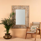 Carved mango wood mirror Anumati with floral motifs and distressed finish. A handcrafted Indian furniture piece perfect for vintage home decor and artisanal interiors.